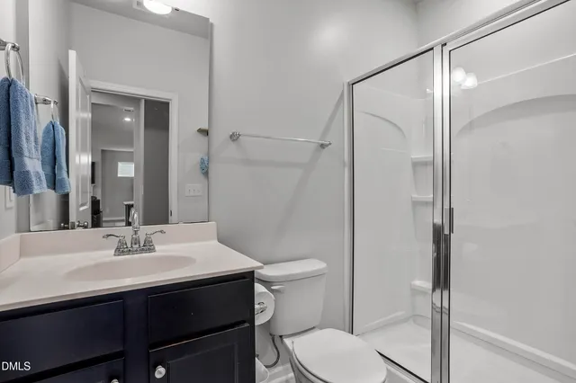 a view of a bedroom with wooden floor and furniture