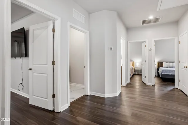 a bedroom with a bed table and a window