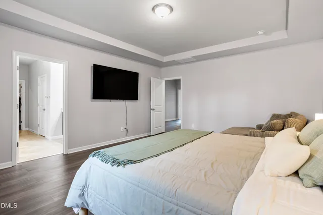 a bathroom with a granite countertop double vanity sink and a mirror