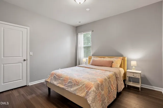 a bed sitting in a bedroom next to a window