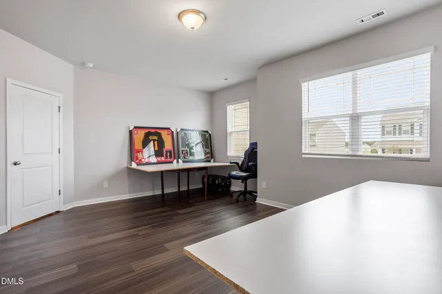 a view of a livingroom with furniture and a window