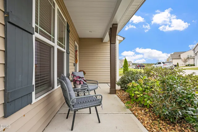 a balcony with furniture and a potted plant