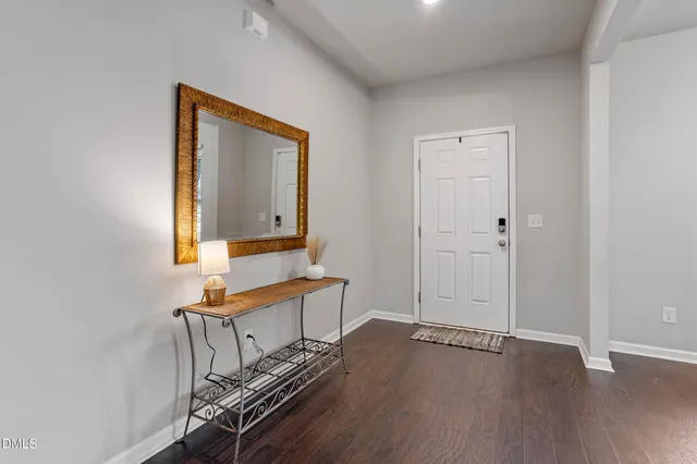 a workspace with wooden floor and a chandelier