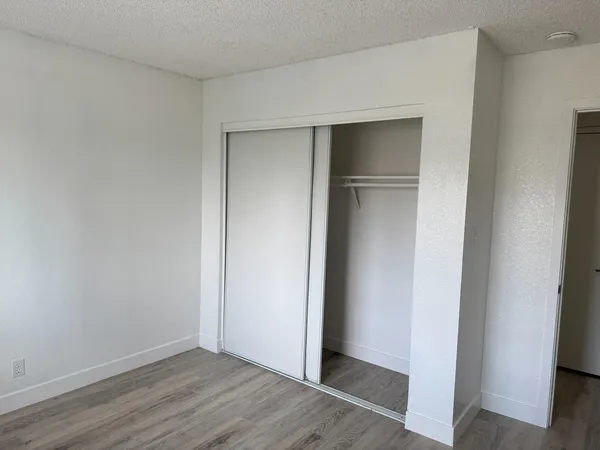 a kitchen with a sink cabinets and wooden floor