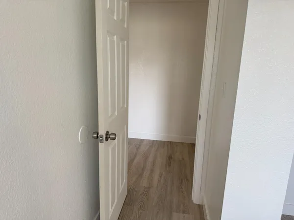a view of walk in closet with empty racks