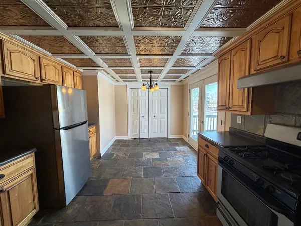 a kitchen with stainless steel appliances granite countertop a refrigerator and a stove