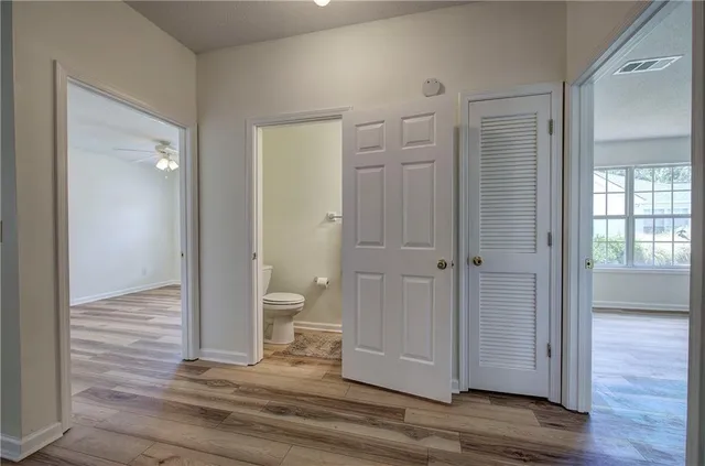 a view of a bathroom with wooden floor
