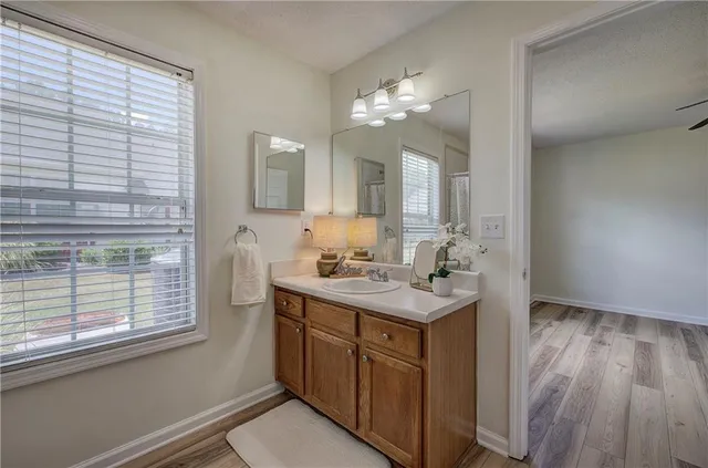 a bathroom with a sink a large mirror and vanity