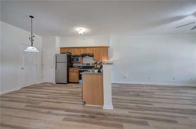 a view of a kitchen electric appliances and cabinets