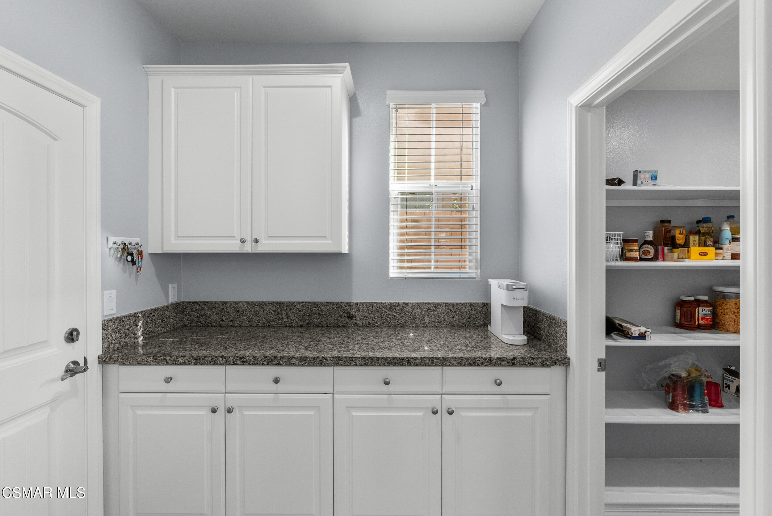 161 White Bark Lane Simi Valley, CA 93065 - Photo 36 of 83 a kitchen with granite countertop cabinets and window