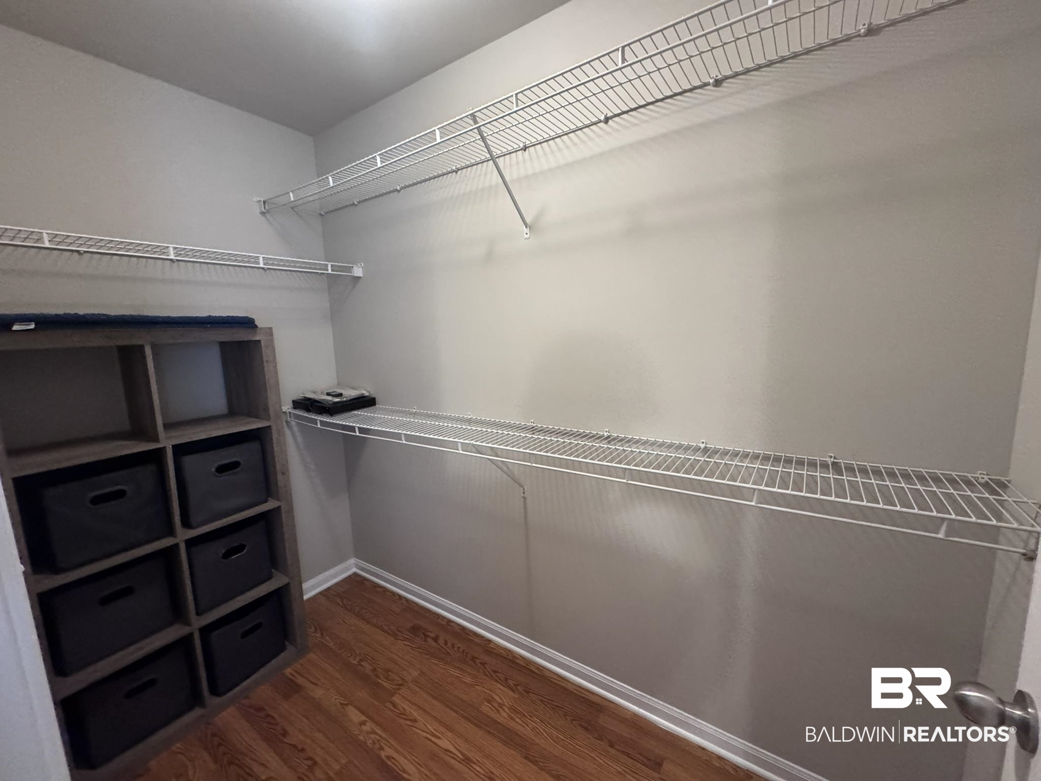 1517 Regency Road, Unit 131 Gulf Shores, AL 36542 - Photo 13 of 21 Walk in closet with dark wood-style flooring