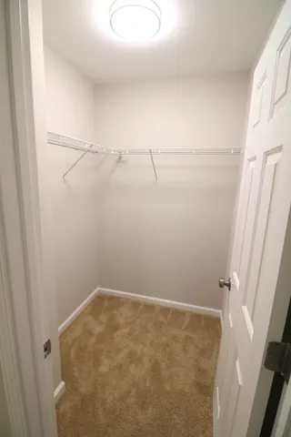 a view of a livingroom with a ceiling fan and window