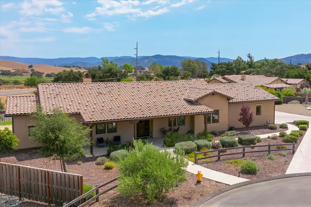 an aerial view of a house with garden space and street view