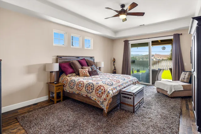 a bedroom with a bed a couch and a window