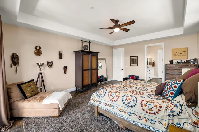 a living room with a bed furniture and kitchen view