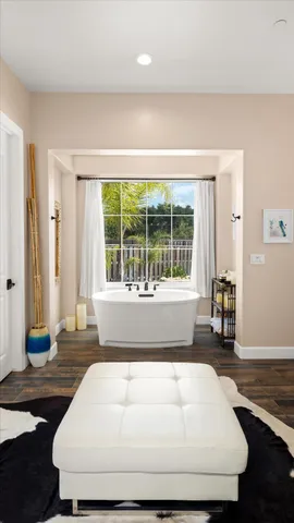 a white bath tub sitting in a bathroom next to a window