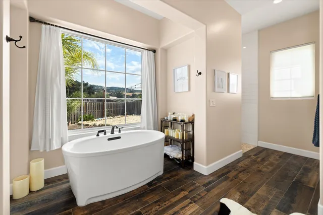 a spacious bathroom with a bathtub and next to a window
