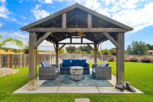 a view of swimming pool with seating area and trees around