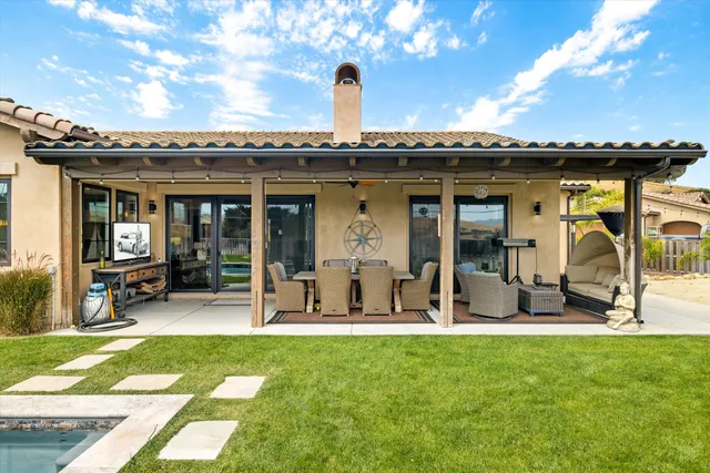 a view of a backyard with sitting area