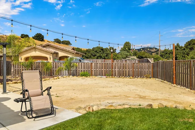 a view of a house with a yard and furniture