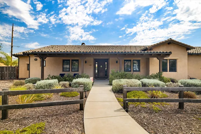 a front view of house with yard outdoor seating and barbeque oven