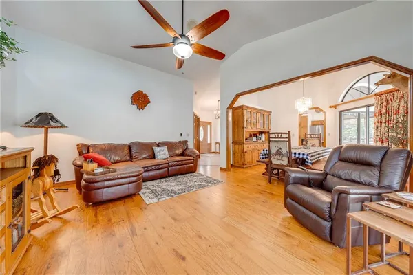 a spacious bedroom with a bed and dresser with mirror