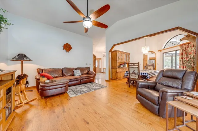 a spacious bedroom with a bed and dresser with mirror