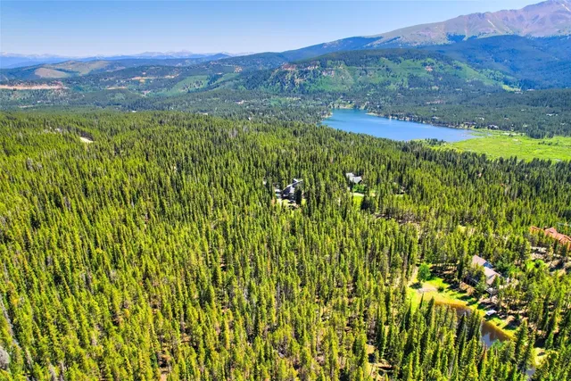 a view of a lush green hillside and a building