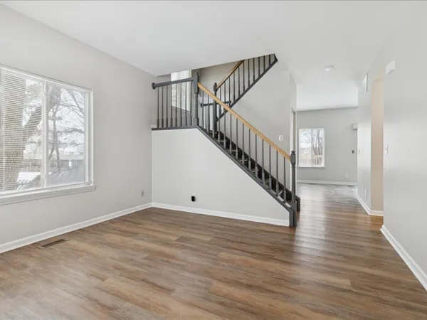 a view of an entryway with wooden floor