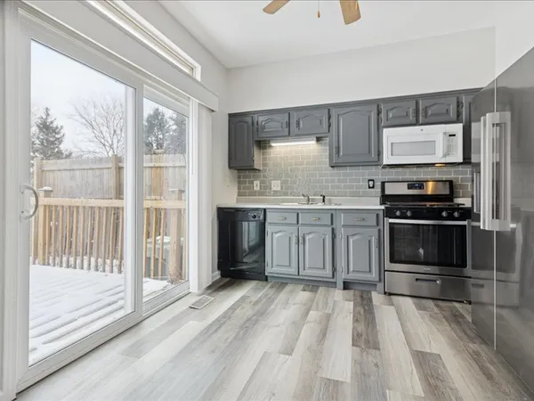 a kitchen with stainless steel appliances a stove a sink and a refrigerator