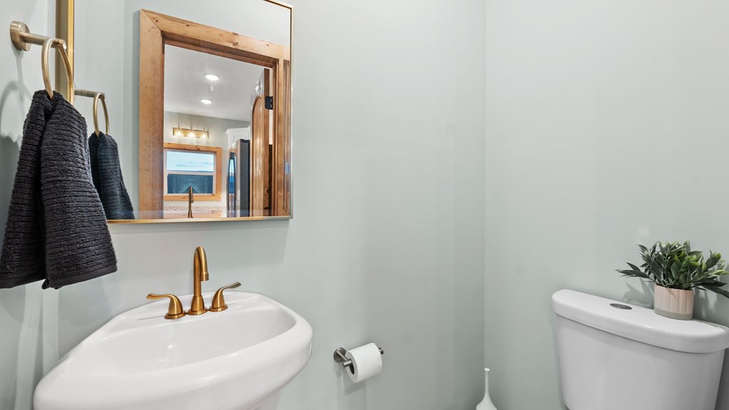 269 Old Orchard Road Ellijay, GA 30536 - Photo 5 of 17 a bathroom with a toilet sink and mirror