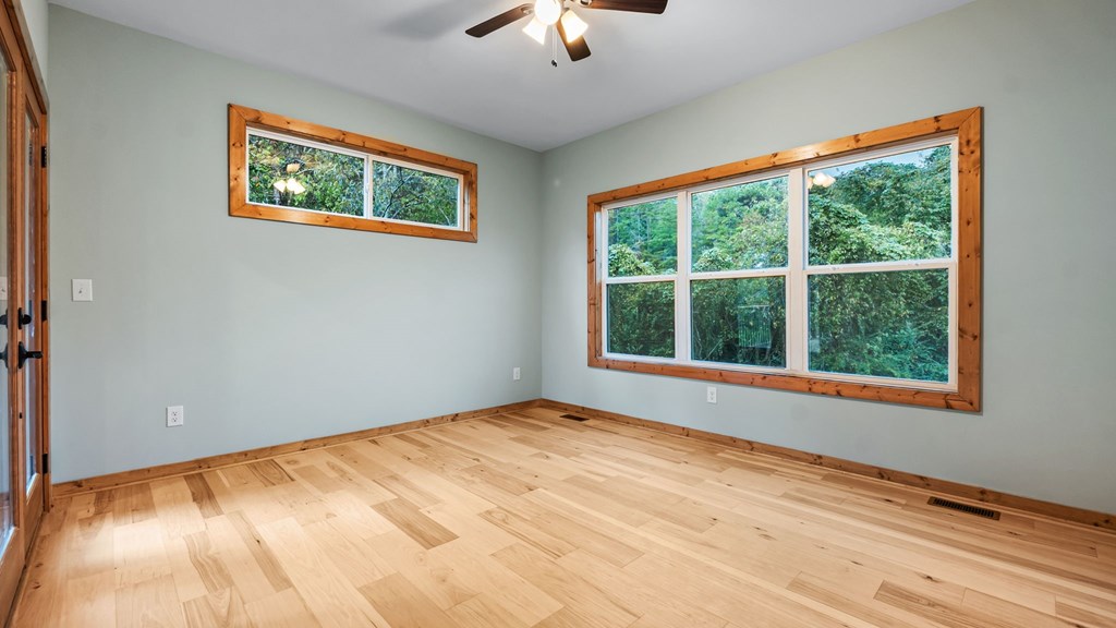 269 Old Orchard Road Ellijay, GA 30536 - Photo 6 of 17 a view of an empty room with window and a chandelier fan
