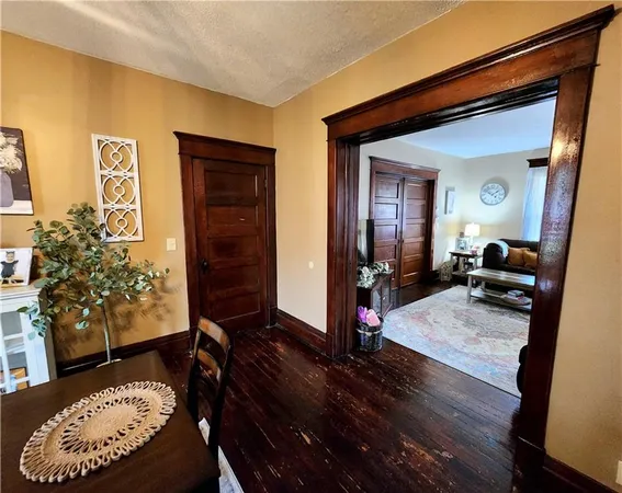 a kitchen with stainless steel appliances a refrigerator a sink a stove a table and chairs