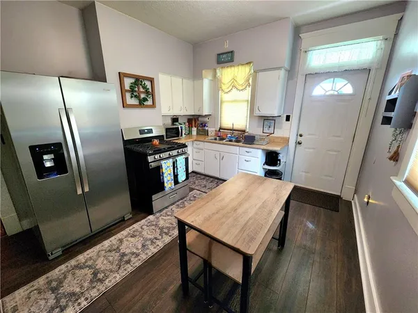 a kitchen with a refrigerator and furniture