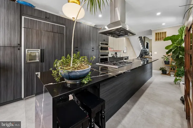 a kitchen with a sink stainless steel appliances and cabinets
