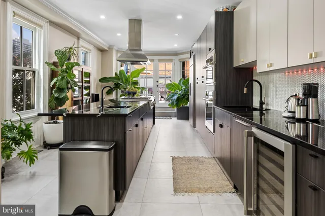 a kitchen with kitchen island granite countertop lots of counter top space and wooden floor