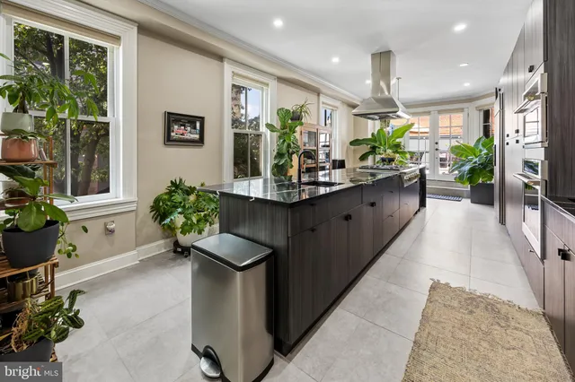 a kitchen with counter top space and living room