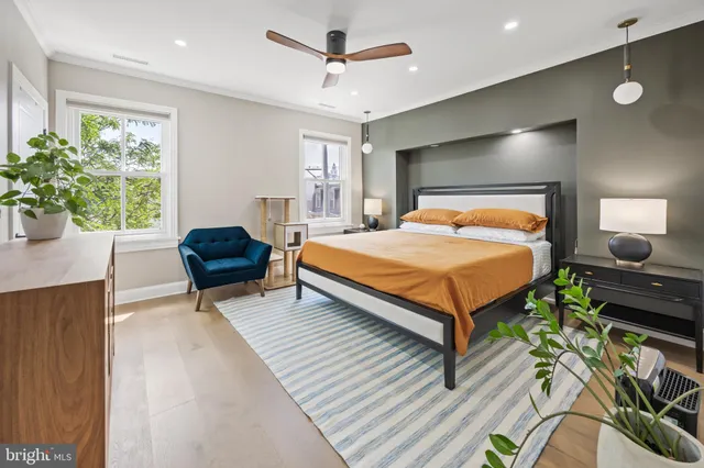 a bedroom with a bed and a potted plant