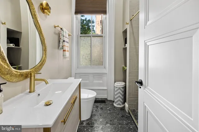 a bathroom with a sink mirror toilet and bathtub