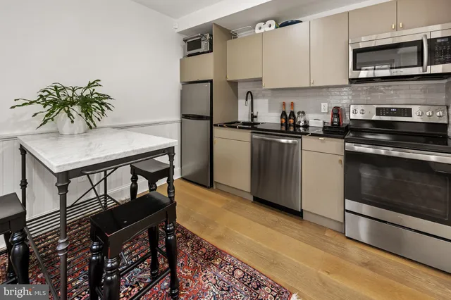 a kitchen with stainless steel appliances granite countertop a stove a refrigerator and a microwave