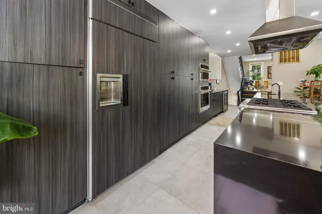 a kitchen with stainless steel appliances a refrigerator and a sink