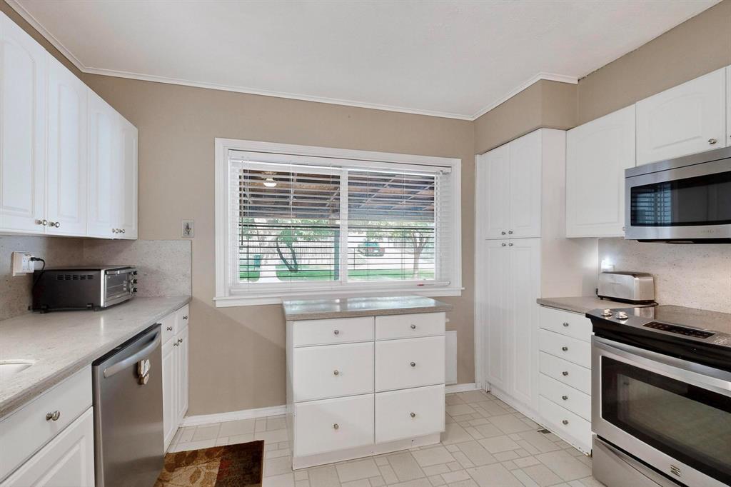 4324 Mesa View Drive Mesquite, TX 75150 - Photo 11 of 39 a kitchen with white cabinets and appliances