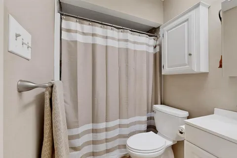 a white toilet sitting next to a bathroom sink