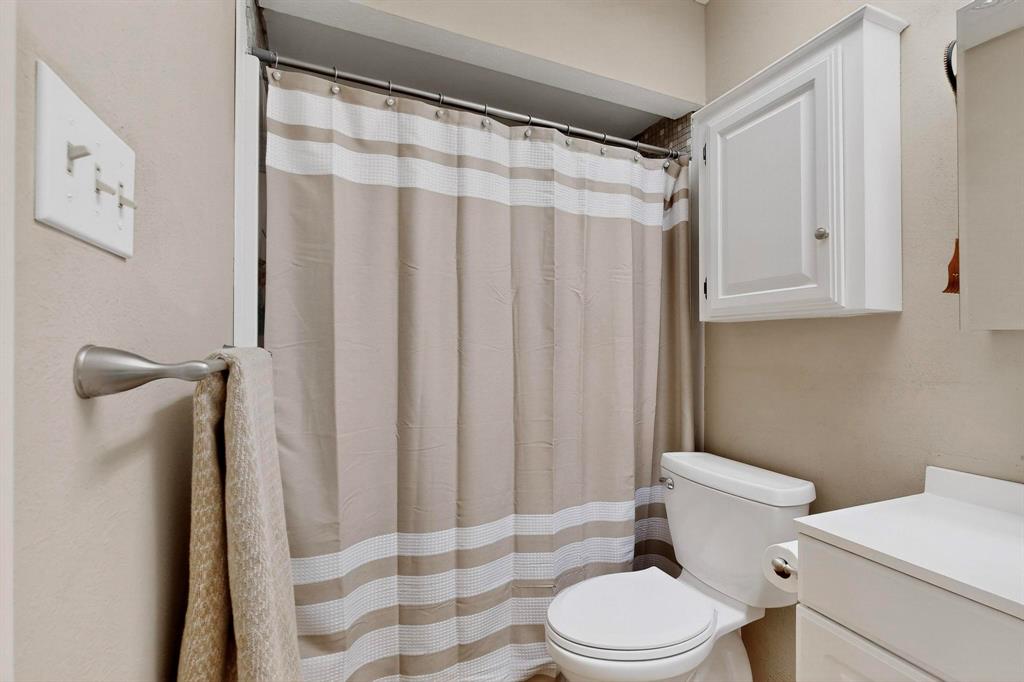 4324 Mesa View Drive Mesquite, TX 75150 - Photo 20 of 39 a white toilet sitting next to a bathroom sink