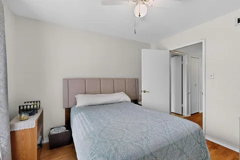 a bedroom with a bed and a hallway