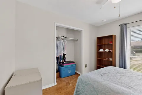 a bedroom with a bed and a large mirror