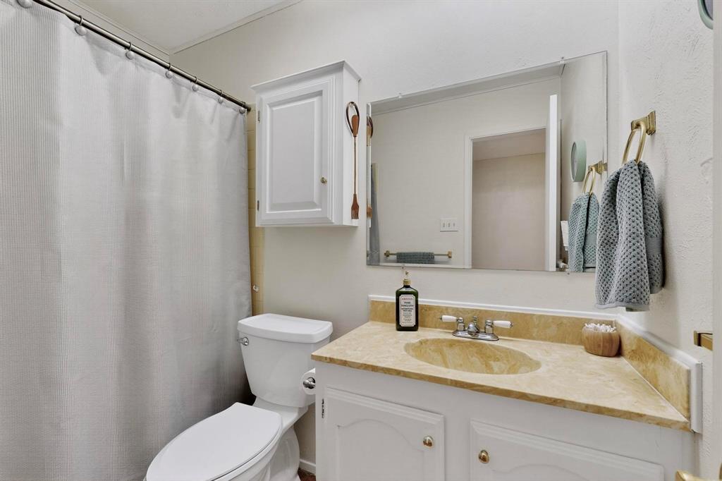4324 Mesa View Drive Mesquite, TX 75150 - Photo 25 of 39 a bathroom with a granite countertop sink and a mirror