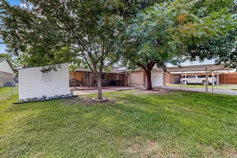 a house view with a sitting space and garden