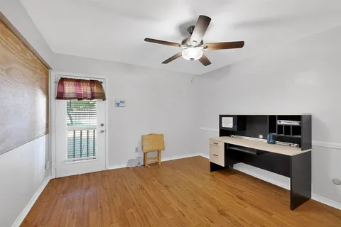 a bedroom with a bed and a desk