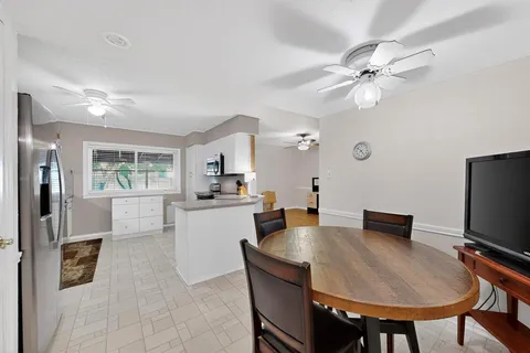 a kitchen with a table chairs and refrigerator